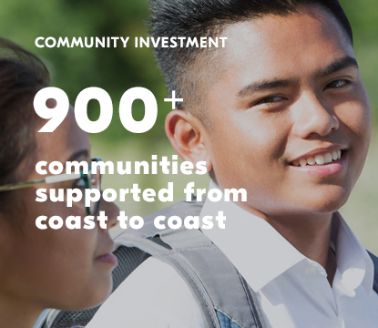 Young boy wearing a backpack, smiling at a girl.